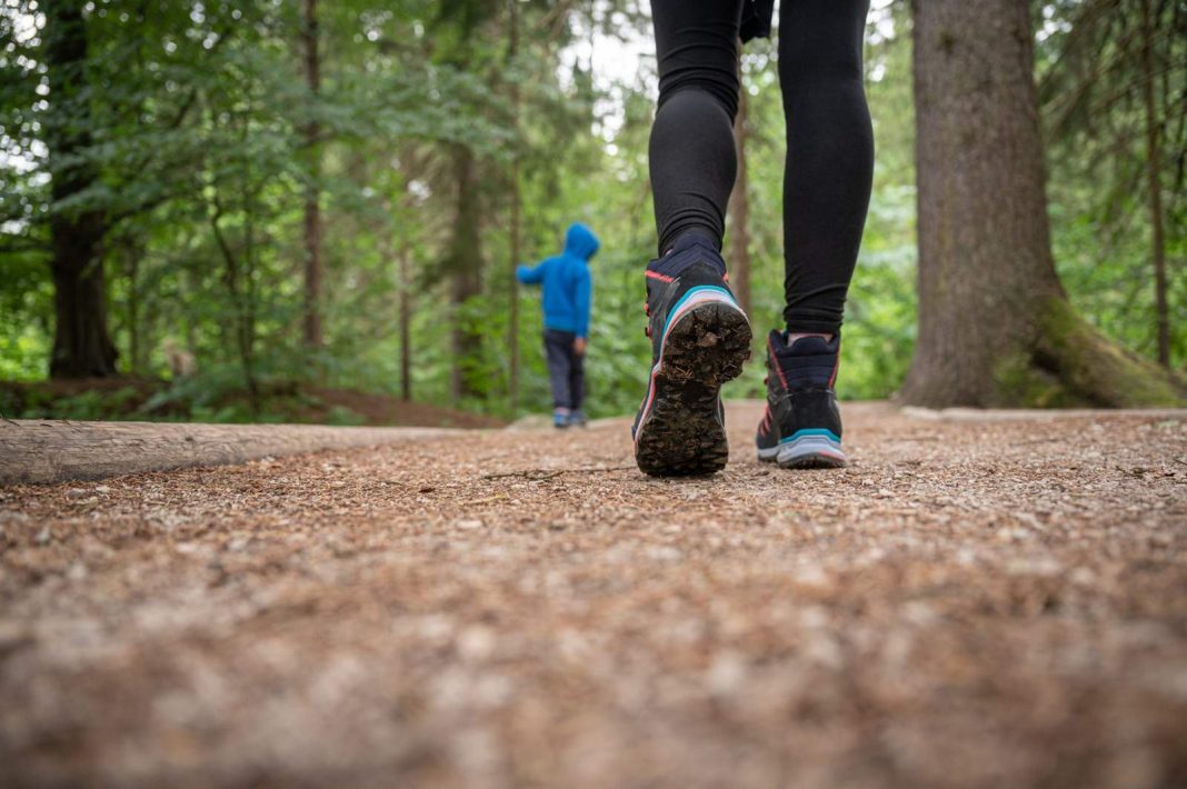 woman-in-hiking-boots-on-a-trail-2023-11-27-05-11-14-utc
